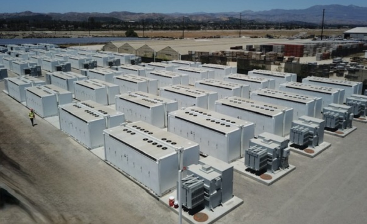 Large power facility with rows of containerized equipment and gray transformers